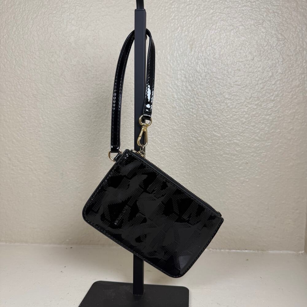 Michael Kors black patent leather wristlet featuring iconic MK monogram pattern